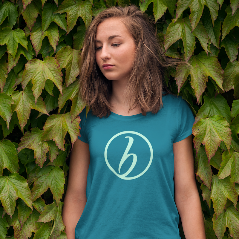A photo of a girl wearing a shirt with the Her Breakthrough logo on the front