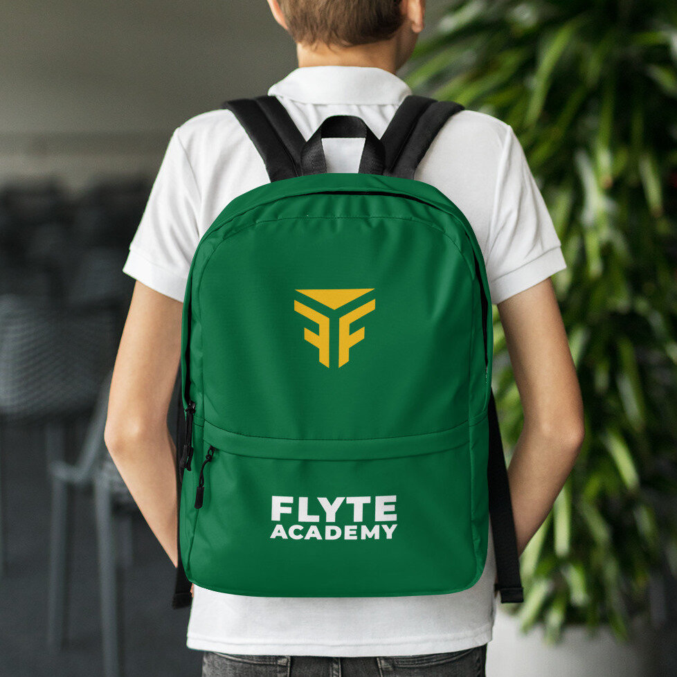 A photo of a boy wearing a green backpack with the FLYTE Academy logo